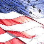 A backlit image of the American flag