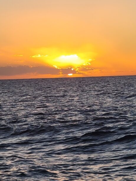 Sunset over the Pacific Ocean, off the Nā Pali Coast of Kauaʻi, Hawaii. 