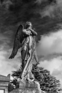 A statue of an angel with her arms crossed on her chest | Snow, Silence, and the Difficult Question of How We Die