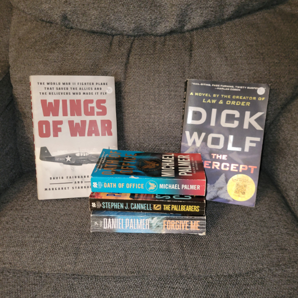 Five books on a couch: Wings of War, The Intercept, Oath of Office, The Pallbearers, Forgive Me. | Searching for Accountability in an Unaccountable World